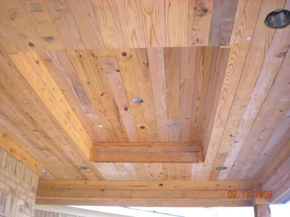 Tongue-and-groove pine porch ceiling with a recessed tray and light cutouts, before finish