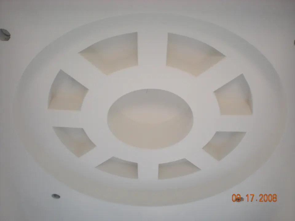 Drywall ceiling medallion with a ring of recessed coffers, ready for paint